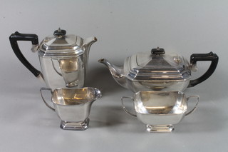 A lozenge shaped 4 piece silver plated tea service comprising teapot, hotwater jug, twin handled sugar bowl and milk jug