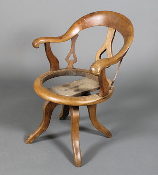An early 20th Century mahogany swivel arm chair
