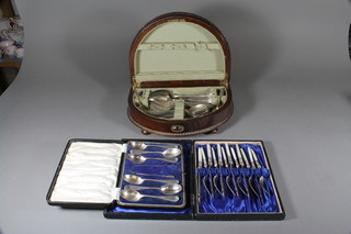 A set of 6 silver plated fish knives and forks with mother of pearl handles and a set of 6 silver plated teaspoons and a crescent shaped canteen box containing a collection of plated flatware