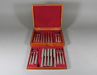 A set of 22 Georgian silver bladed fruit knives and forks comprising 12 forks and 10 knives, contained in a walnut canteen box