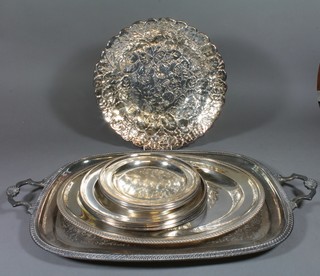 An oval engraved silver plated twin handled tea tray 20", an oval silver plated meat platter with galleried border 16", circular leaf shaped dish 13.5", 3 platters 10" etc