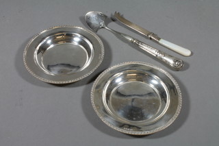A pair of circular silver dishes, Sheffield 1932, 6 ozs, a marrow scoop with silver handle and a cheese knife