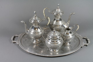 An Eastern engraved silver 5 piece tea/coffee set comprising oval tea tray, teapot, coffee pot, milk jug and sugar bowl, marked 84, 124 ozs ILLUSTRATED