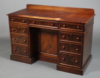 A Victorian mahogany kneehole desk fitted 9 drawers with recessed door on pedestal base 33" x 48"  x 21.5" 