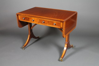 A Regency style  crossbanded mahogany sofa table on splayed legs 28"h x 57"w x 20"d