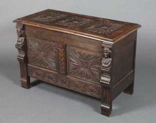 A carved oak coffer with figural decoration and carved panels 24"l x 36"w x 17"h