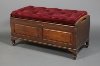 A carved camphor wood coffer with carrying handles and panelled front on cabriole legs with swab cushion