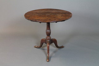 A Georgian oak tripod table, raised on a turned column, tripod supports