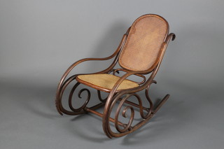 An early 20th Century bentwood rocking chair with cane panels