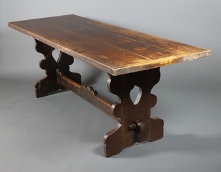 A late 19th Century oak refectory table on pierced supports and straight stretcher 30"h x 83"w x 30"d 