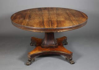 A 19th Century rosewood Loo table on octagonal waisted stem and quatrefoil base with claw feet 28"h x 51" ILLUSTRATED