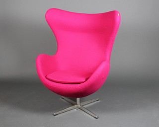 A 1960's style high backed swivel armchair on a chrome stand