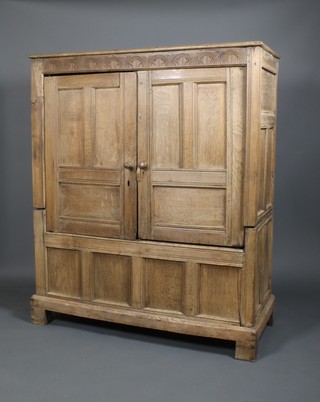 A 17th Century panelled oak press with double doors and panelled front on straight legs 66" x 54" x 23"