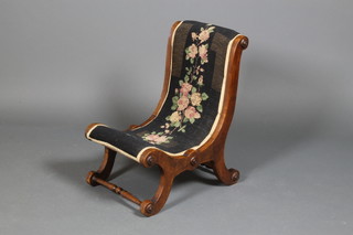 A mid Victorian cross framed stool upholstered with floral wool work embroidery