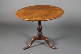 A Georgian mahogany circular tripod table on vase stem with scroll feet 27"h x 32"diam.