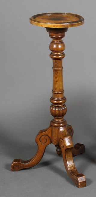 A Victorian carved oak torchere on scroll legs 33" x 11" 