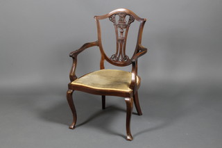 An Edwardian carved mahogany shield shaped elbow chair on cabriole legs