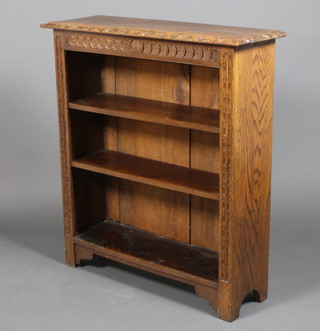 A carved oak open 3 tier bookcase, raised on straight legs 40" x 36" x 12"