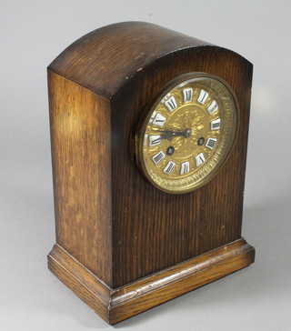 An oak cased mantel clock with earlier brass movement 10"h 