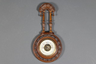 An Edwardian carved walnut banjo barometer
