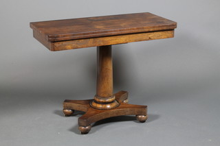 A 19th Century rosewood card table, raised on a tapered stem and quatrefoil base with bun feet 28" x 36" x 18" ILLUSTRATED