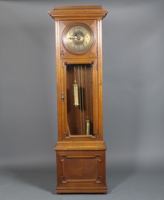 A 1930's carved oak longcase clock with brass dial and glazed door, on a plinth base 77"h 