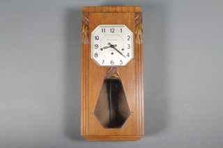 A French Art Deco chiming wall clock with octagonal silvered dial marked Massart Pont, Fougepes, contained in a walnut case, (worm)