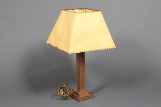 An Art Nouveau style embossed copper table lamp, raised on a square stepped foot 14"