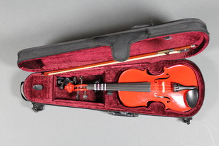 A childs red Rainbo violin, size 3/4, cased and complete with bow 