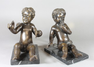 A pair of modern bronze figures of seated Putti with musical instruments, raised on marble bases 11"h x 9"l