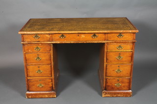 A Victorian pine pedestal desk with inset green leather writing surface above 1 long and 10 short drawers 29"h x 54"w x 24"d