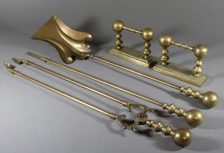 A pair of brass fire dogs and a 3 piece fireside companion set comprising shovel, poker and tongs