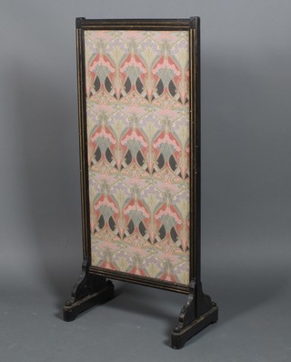 An Edwardian ebonised secessionist style fire screen with Liberty panel 23" 
