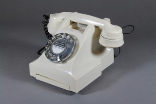 A white Bakelite dial telephone