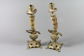 A pair of 19th/20th Century German candlesticks formed from the hilts of hunting swords with stag horn grips, blades marked Solingen 12" ILLUSTRATED