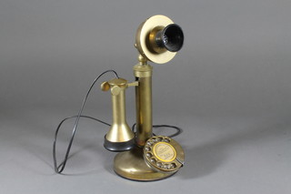A reproduction brass candlestick telephone