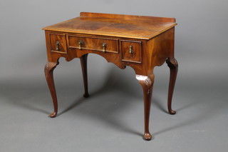 A crossbanded mahogany 3 drawer desk, raised on cabriole legs with shell knees and pad feet 30" x 36" x 21"