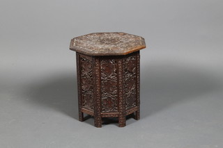 A carved oak octagonal coffee table with vineous decoration 18"