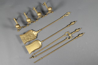 2 pairs of brass fire dogs together with a 3 piece brass fireside companion set comprising tongs, poker and shovel together with a brass shovel