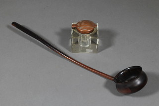 An Art Nouveau square glass inkwell with embossed copper lid 2" together with a turned lignum vitae ladle