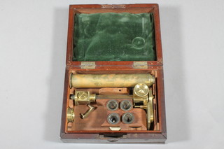 A 19th Century brass single pillar microscope on a triform base, marked Carpenter & Westley of 24 Regent Street London