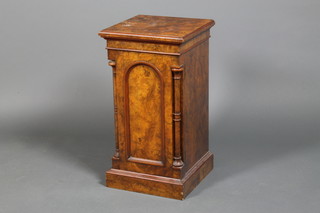 A mid Victorian walnut pot cupboard with panelled domed door, flanked by columns, raised on a plinth base 28" x 15" x 15"