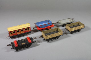 A Hornby no.1 lumber wagon RS668, a Hornby no.0 wagon W603, a Hornby no. 0 rotary tipping wagon SR704, a flat truck SR705, and a O gauge wagon, all boxed and a Pulman carriage