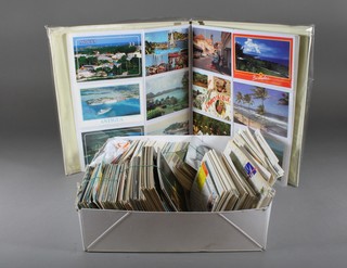 A collection of various postcards and an album of postcards