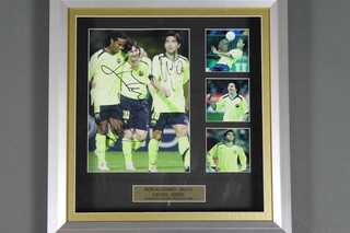 A signed photograph of Lionel Messi, Ronaldinho and Decco, with certificate of authenticity 11" x 12"