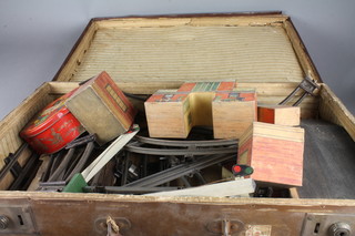A suitcase containing various rails and wooden railway buildings