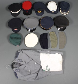 A Kent Fire Brigade peak cap, a French capy, a St John Ambulance Brigade peak cap, various other caps and a military jacket