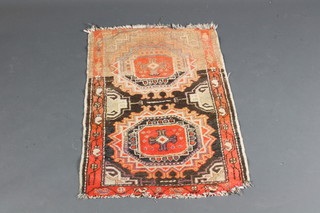 A Caucasian style rug with 2 octagons to the centre 37" x 24"
