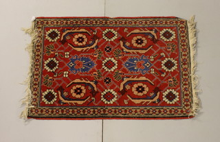 A peach coloured Persian slip rug with stylised gulls 36" x 24"