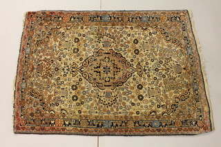 A North West Persian pink ground and floral patterned rug with central medallion 59 1/2" x 42"